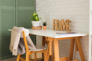 Workplace with plants and decor in room