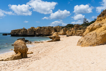 São Rafael beach, Albufeira, Algarve, Portugal. Sunny day. Rocks and cliffs on the beach. Crystal...