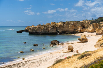 São Rafael beach, Albufeira, Algarve, Portugal. Sunny day. Rocks and cliffs on the beach. Crystal clear sea