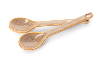 Ceramic beige spoons on white background