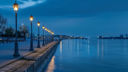 Obraz premium A scenic riverfront promenade with tranquil waters, charming shops, and inviting cafes.