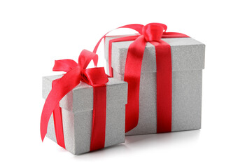 Gift boxes tied with red ribbon on white background