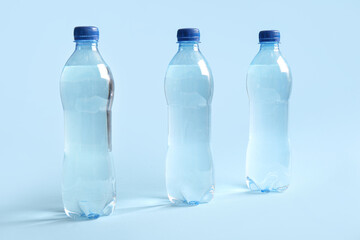 Plastic bottles of water on blue background