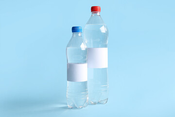 Bottles of clean water on blue background