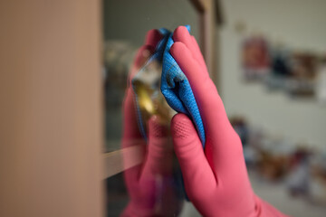 A person is using a cloth to clean a window