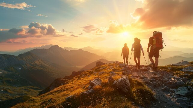 Three hikers with backpacks trekking a mountain trail at sunset, with golden light.