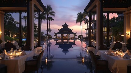 Luxurious outdoor dining experience at an exotic beachfront resort during a breathtaking sunset, surrounded by palm trees and a beautifully lit pool area