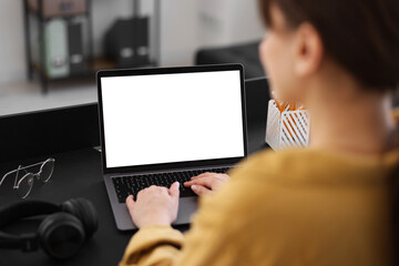 Woman watching webinar at table in office, closeup