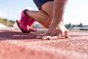 Close-up of runner ready to run on starting line