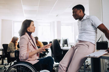 Caucasian woman with disability and an african american man having a meeting
