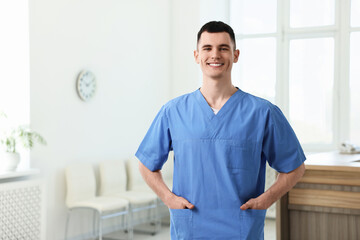 Smiling medical assistant in hospital. Space for text