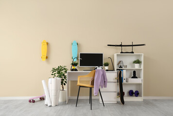 Interior of teenager's room with workplace, plants and skateboards