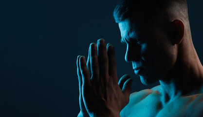 Muscular model sports young man on dark background. Fashion portrait of strong brutal guy. Male...