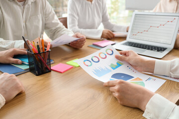 Business people with diagrams working on marketing plan in office, closeup