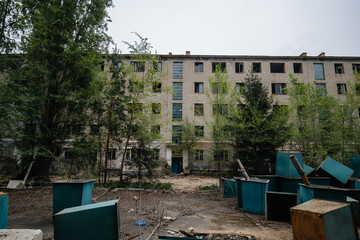 Abandoned white brick multistory houses, decaying cityscape of ghost town