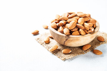 Almond nuts at white background. Healthy vegan food, omega 3.