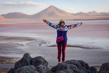 A happy tourist on the background of the Colorado lagoon. Bolivia