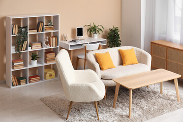 Interior of modern living room with sofa and bookshelf near beige wall