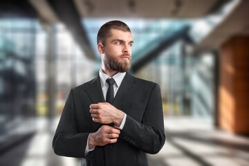 Happy proud professional businessman standing in office