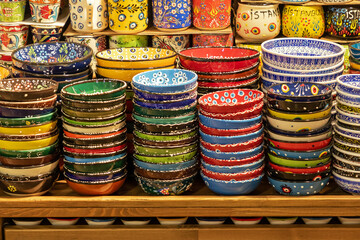 Stack of colorful ceramic bowls and plates sold on outdoors market in Istanbul