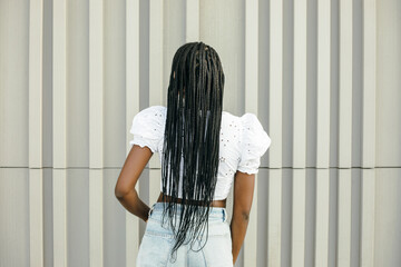 Back view of unrecognizable black female with long braided hair