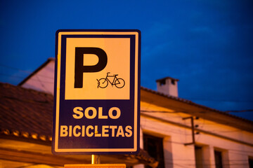 sign for a bicycle parking lot, isolated from the background at night