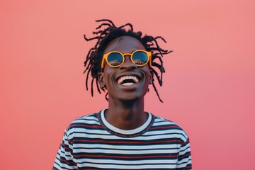 Unique Face. Smiling African American Young Man with Sunglasses and Happy Sign in Pink Background