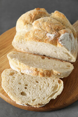 Freshly baked cut sourdough bread on grey table, closeup