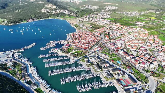 Aerial high quality view of Izmir tourist village Sigacik, its historical castle, fishing shelter and Teos marina