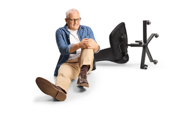 Man with an injured knee sitting on the ground next to an office chair