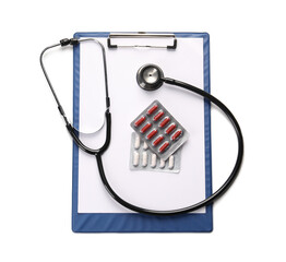 Clipboard, pills and stethoscope on white background, top view