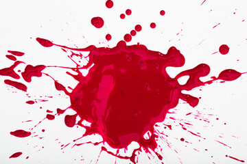 Splash and splatters of spilled paint of red color on white surface..