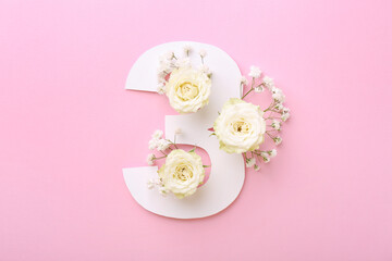 Paper number 3 and beautiful flowers on pink background, top view
