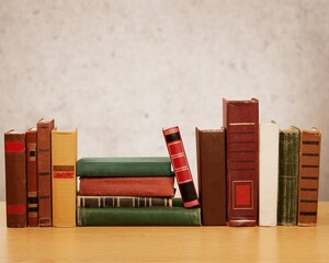 Old books row on desk background
