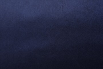 Texture of dark blue silk fabric as background, top view