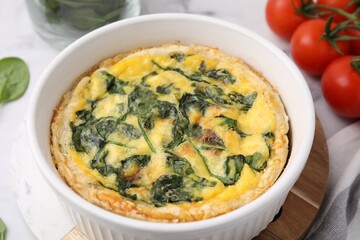 Delicious pie with spinach on table, closeup