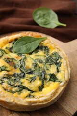 Delicious pie with spinach on table, closeup