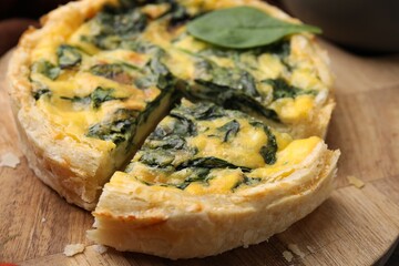 Delicious pie with spinach on table, closeup