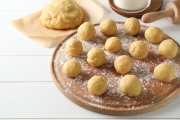 Shortcrust pastry. Raw dough balls on white wooden table