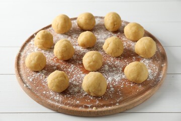 Shortcrust pastry. Raw dough balls on white wooden table