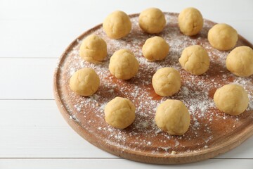 Shortcrust pastry. Raw dough balls on white wooden table