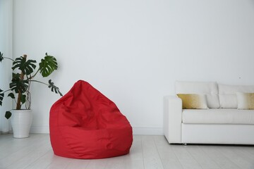 Red bean bag chair on floor in room