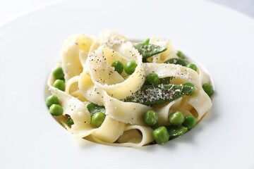 Delicious pasta with green peas on plate