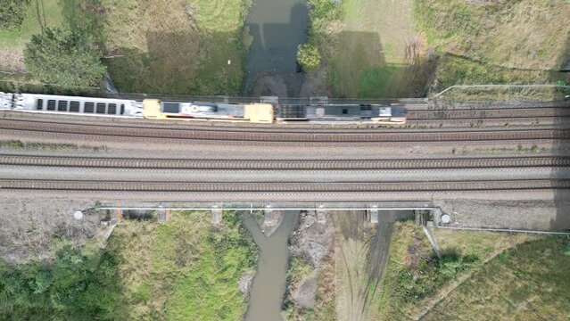 Looking down on freight train crossing a small bridge