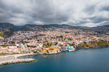 Aerial view of a drone flight over Funchal coastline in Madeira island in sunny day