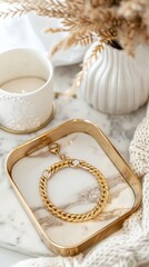 Gold bracelet on a marble tray. Light and airy summer photography for social media faceless digital content marketing
