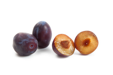 Fototapeta premium Two Whole and Halves purple plums isolated on white background. .