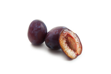 Two Whole and Halves purple plums isolated on white background. .