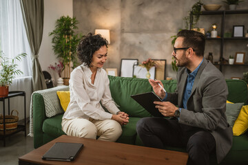 Mature woman talk with adult man about document she need to sign