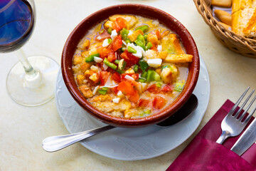 Cojondongo, typical summer dish from Extremadura with chopped tomatoes, pepper and eggs, day-old...